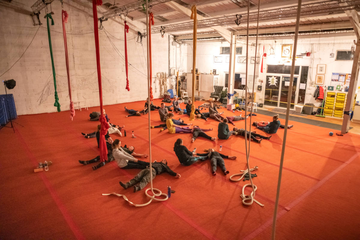 Aerialists partner stretching after training