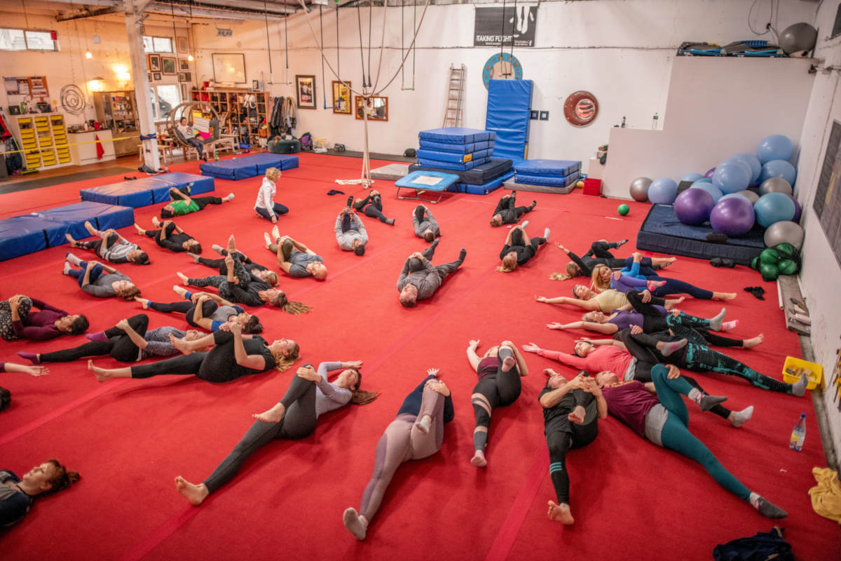 Acrobats stretching after training